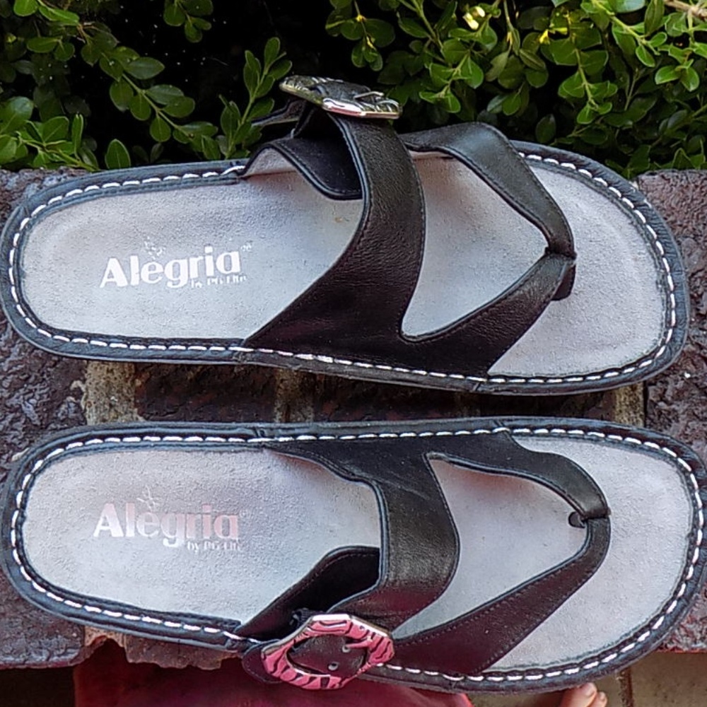 Alegria Black Leather Thong Sandals with Pink Buckle Accent